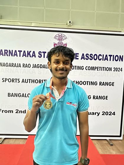Darren with his gold medal from the Air Pistol Men's team event.