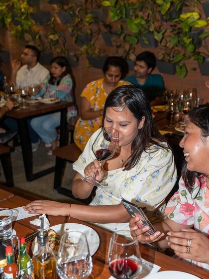 A candid shot of guests laughing and enjoying themselves at our wine and pizza night.