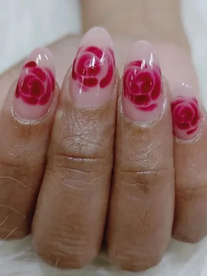 A unique and artistic design featuring a translucent blooming rose effect painted within the nail.