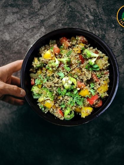 My vibrant Quinoa Salad, held up to showcase its colorful medley of fresh veggies and protein-packed quinoa. It's a deliciously nutritious choice to fuel your day.