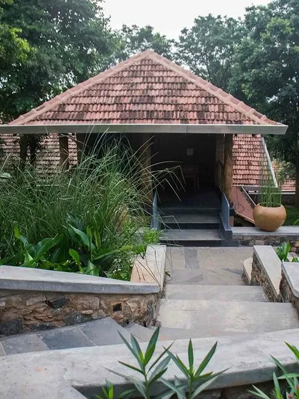 The entrance to one of the buildings at PLENTI House, with stone steps curving gently up through the garden.