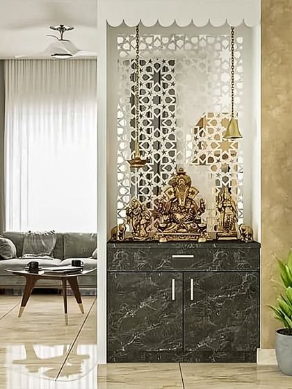 This pooja unit is designed as a semi-open partition, with a beautiful CNC-cut screen. The marble-finish base cabinet provides storage, creating a divine corner in the living room.