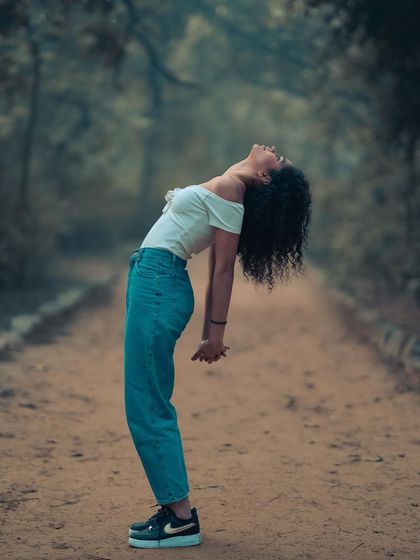 A dynamic pose against a moody, atmospheric background. The cool tones of the forest path create a cinematic feel that I love.