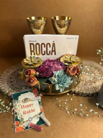Another view of my royal Rakhi hamper, this time with elegant brass tumblers. It’s a perfect blend of traditional materials and modern luxury, complete with a beautiful rakhi and roli-chawal.