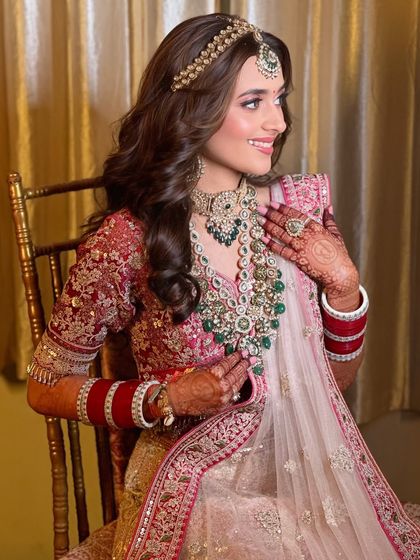 This side profile highlights the delicate jewelry and the soft, glowing makeup that enhances her features without overpowering them.