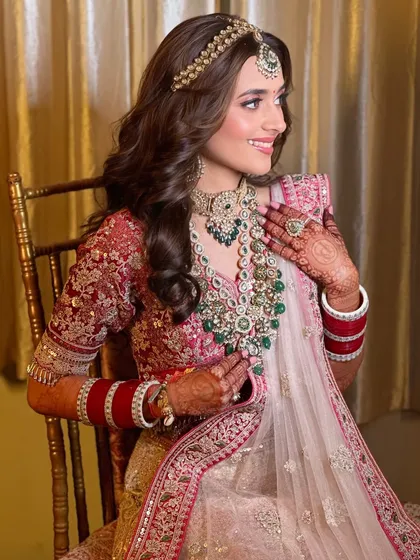 This side profile highlights the delicate jewelry and the soft, glowing makeup that enhances her features without overpowering them.