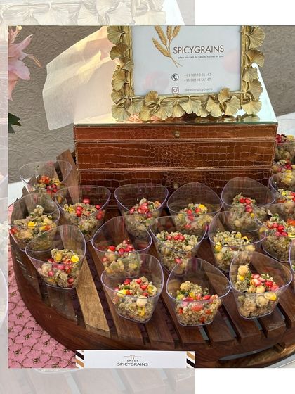 Healthy and beautiful. Our quinoa cups, garnished with pomegranate seeds, are a popular choice for health-conscious guests, served elegantly on a wooden platter.