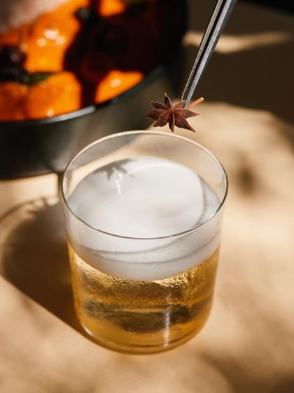 The art of the garnish. A single star anise is carefully placed on the foam of our Cuban Sour, a final touch before it reaches your table.