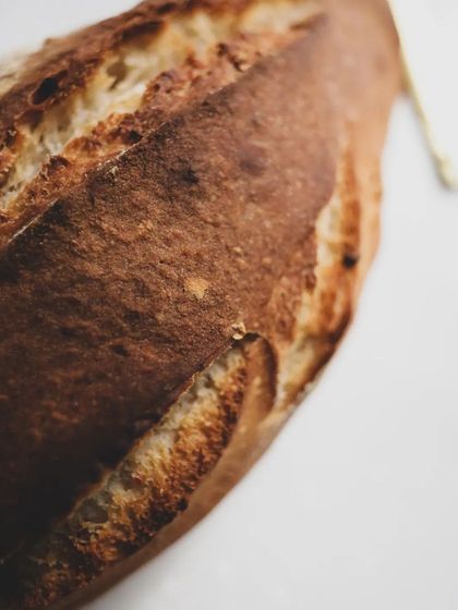 A close-up of a rustic, artisan-style loaf. The beauty is in the crust.