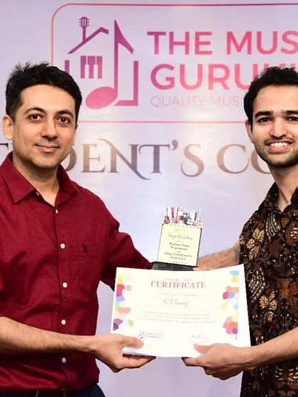 Our founder presenting a certificate and trophy to a student at the concert. We believe in recognizing and celebrating the hard work and dedication of every performer.