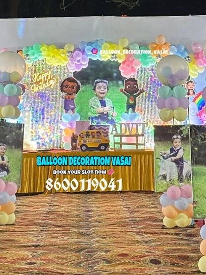 A Cocomelon themed entrance for a first birthday party. This outdoor setup features character photo standees and pastel balloon pillars to welcome guests.