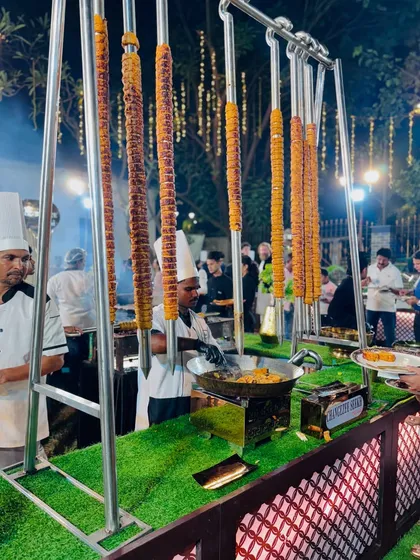 An impressive display of Changezi Seekh hanging vertically, a unique presentation that adds a visual flair to the barbecue counter.