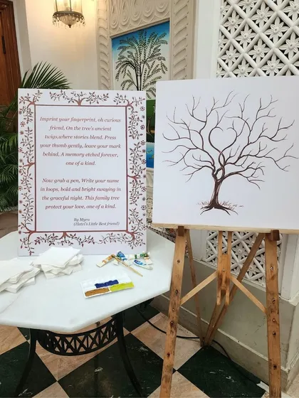 A unique guest book idea: a "fingerprint tree" where guests add their thumbprints as leaves on the tree, creating a beautiful keepsake for the couple.