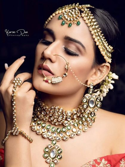 A professional shot of a model wearing a Pachi Kundan set with a delicate nath and hathphool. This highlights the fine craftsmanship of my pieces.