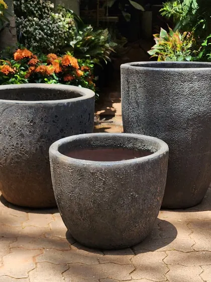 I've just received these new planters with a black lava glaze. The rough, volcanic texture gives them a powerful, earthy feel. They are available in a set of three different sizes to create a cohesive cluster.