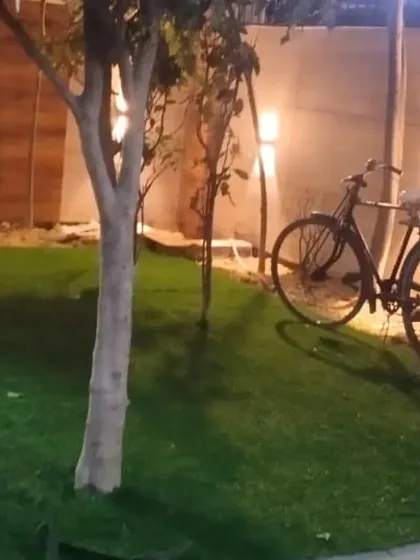The same project in Kaushambi, showing how the new lawn, combined with lighting and decorative elements, creates a beautiful community space in the evening.