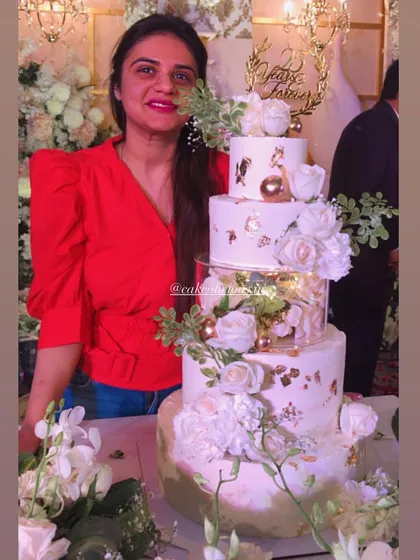 My first five-tier cake! This magical white and gold creation was for a 25th anniversary. It featured floating tiers with lights, delicate gold leaf, and a cascade of white roses. The top tiers were chocolate mousse and the bottom was classic pineapple.