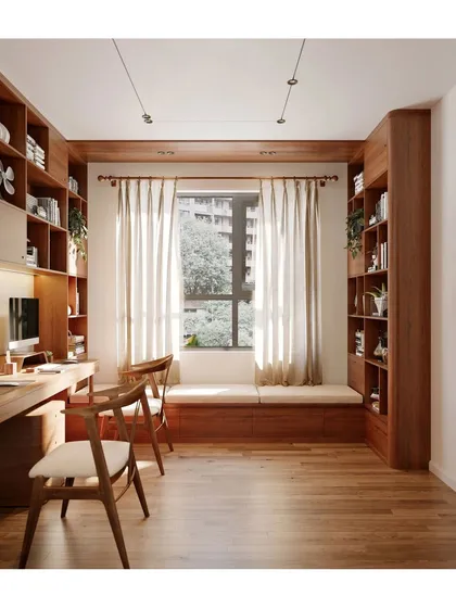 This warm and inviting home office is designed for focus and productivity. We crafted custom floor-to-ceiling wooden bookshelves and a window seat, maximizing storage and creating a comfortable, well-lit workspace.