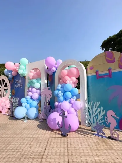 I designed this multi-panel backdrop for a poolside Mehndi party. It combines pastel balloon clusters with nautical and beach-themed cutouts like anchors, seahorses, and coral, creating a unique and stylish photo zone.