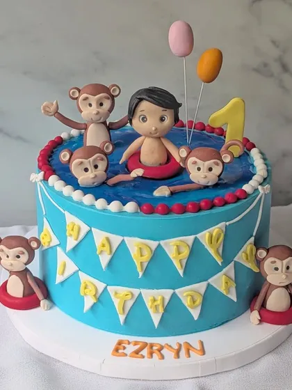 The client went bananas over this one! Ezryn's first birthday was all about monkeying around in style with this fun pool and monkey-themed cake.