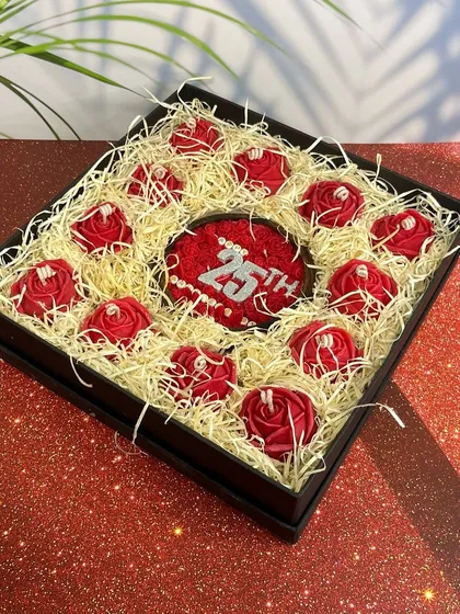 Celebrating a milestone? This 25th-anniversary candle box is surrounded by delicate red rose candles, making it a truly special and romantic gift for a silver jubilee.