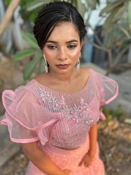 A close-up of the soft pink eyeshadow and glowing skin.