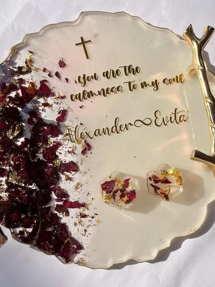 A beautiful ring tray for a Christian wedding, featuring preserved rose petals, the couple's names, and a personal quote. The two ring holders are also made with the same preserved roses.