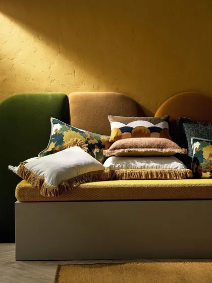 This image from our Fall Winter 2024 Accessories Collection is an ode to refined living. Luxurious textures and intricate, art-inspired designs come together in a sophisticated pile of cushions, where every stitch reflects timeless craftsmanship.