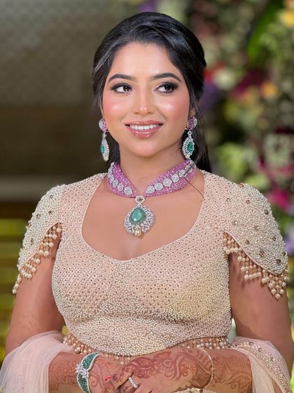 A happy, smiling portrait of the bride, looking radiant and confident in her beautiful reception look.