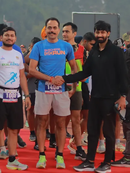 Shaking hands with a participant at the starting line. I make it a point to connect with runners and create a welcoming and encouraging atmosphere.