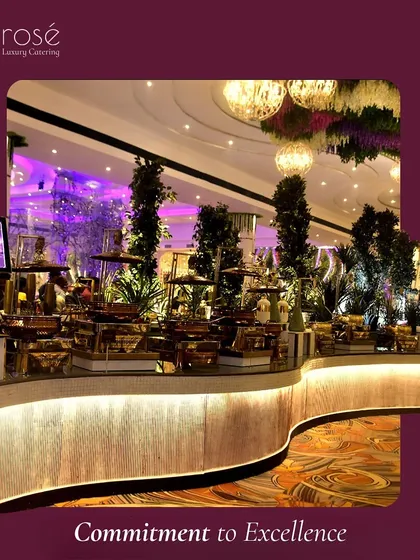 A stunning, curved buffet counter set up in a grand ballroom with floral decor suspended from the ceiling. This image perfectly encapsulates our commitment to excellence in both food and presentation.