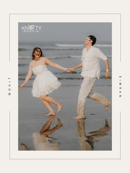 A fun, candid shot of the couple running along the water's edge, their reflections captured in the wet sand. The graphic frame adds a modern, stylish touch to this beach pre-wedding picture.