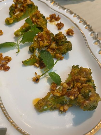 Tandoori broccoli florets topped with crunchy nuts. This is a healthy and delicious appetizer that gives a classic vegetable a smoky, flavorful makeover.
