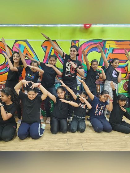 Posing with the pre-teens hip hop crew. We work hard, but we also know how to have fun and strike a pose after a successful rehearsal.