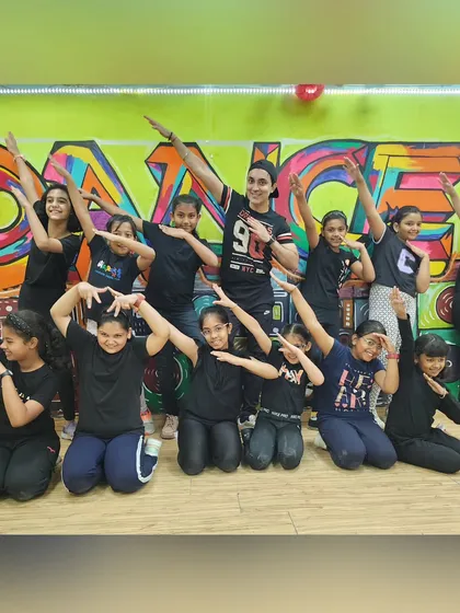 Never miss a chance to dance! This is our motto, and these kids live it every day in the studio, striking a pose after a great hip-hop session.