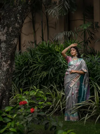 A full-length shot in a garden setting, showing how this saree can be both glamorous and grounded in nature.