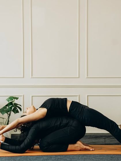 We build heat you can hold. This partner stretch combines a forward fold with a backbend, allowing for a deeper release for both individuals through mutual support.