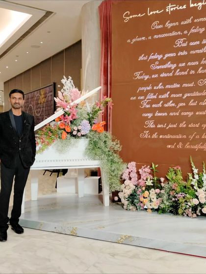Posing by the grand piano and floral decor at the Conrad in Pune.
