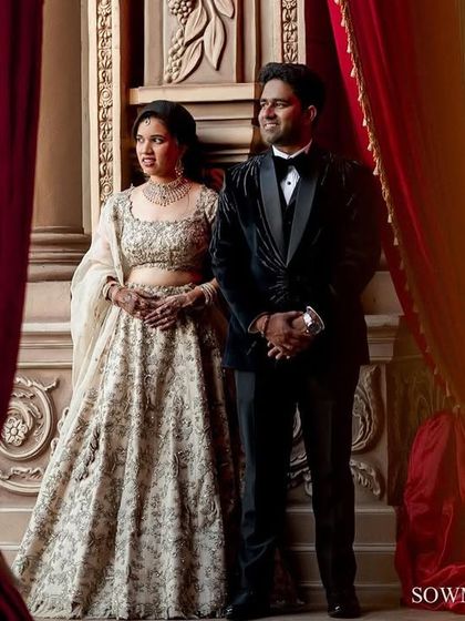 A reception portrait that feels both grand and intimate. The couple stands together against an opulent backdrop, ready to start their new life.