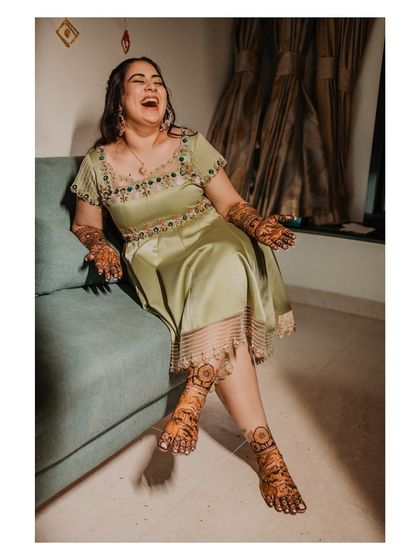 The bride's infectious laughter during her Mehendi ceremony. We aim to capture the real, unfiltered joy of these moments.