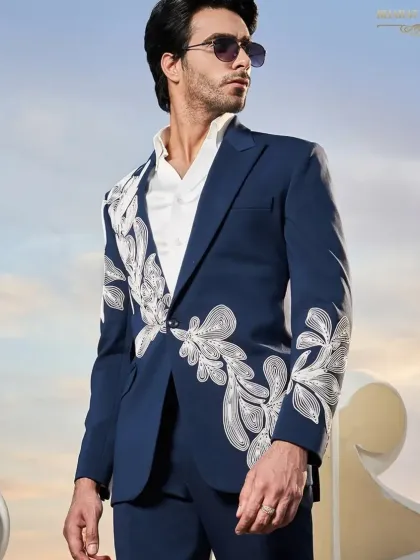 A deep blue tuxedo suit with abstract white embroidery. This piece shows how I can use color and custom embroidery to create a one-of-a-kind formal look.