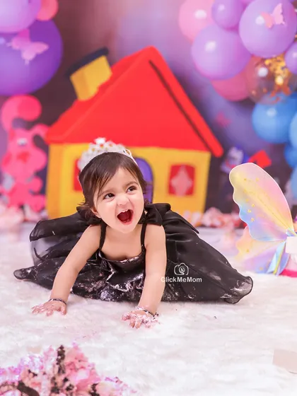 Let the mess begin. A first birthday cake smash is all about letting go and embracing the chaos, and this little princess's joyful expression says it all.