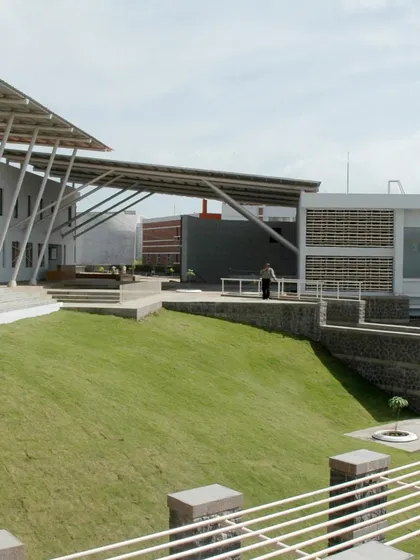 At Symbiosis International University in Pune, the landscape is designed to work with the challenging terrain. The terraced lawns and open plazas create functional outdoor spaces that respect the natural contours of the hill.