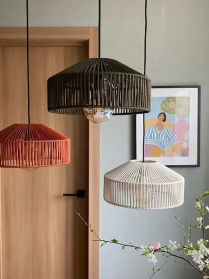 This image showcases our versatile pendant lights available in multiple colors, including terracotta, black, and white. Hanging in a cluster, they demonstrate how different finishes can be mixed to match any color palette while maintaining a cohesive, modern look.