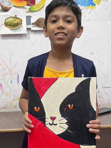 This young man is very pleased with his cat painting. Our classes are open to everyone, and we make sure every child feels successful.