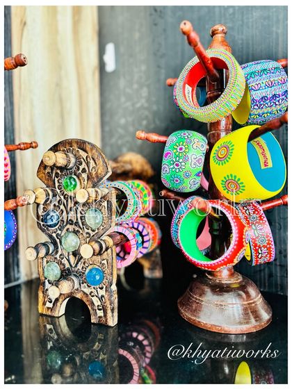 A display of my colorful hand-painted bangles, including the unique carved wooden bangle with colorful stones that I call the 'Abacus' bangle.