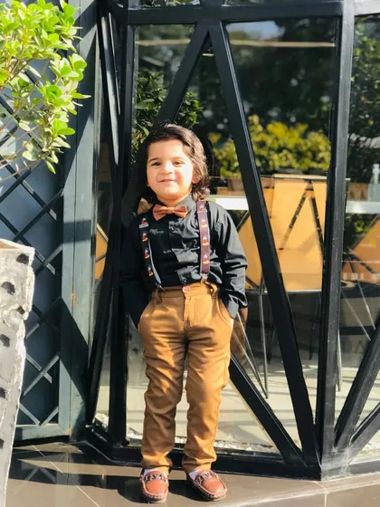 Styling for kids is about capturing their personality. For this magazine editorial, I created a dapper yet playful look with a classic black shirt, brown corduroy trousers, and fun Mickey Mouse suspenders to add a touch of whimsy.
