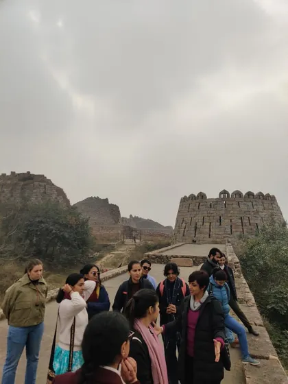 A close-up of our group on the fortifications of Tughlaqabad. The sloping walls are a characteristic feature of Tughlaq architecture, designed for defensive strength.