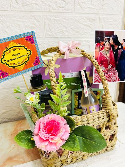 A beautiful Rakhi hamper for a sister, sent from Nepal to Delhi. It includes scented candles, Plum body care products, and is personalized with a photo.