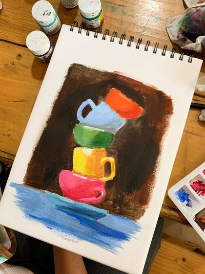 The finished acrylic painting of stacked teacups. This funky and colorful piece by a student is a great example of how to use a bright, vivid palette effectively.